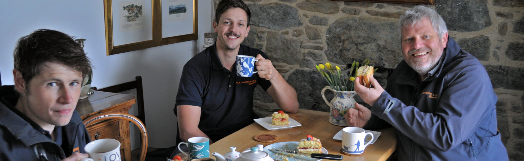 Some of our team enjoying cake, rather than actual cookies, provided by a grateful customer near Helston, Cornwall.